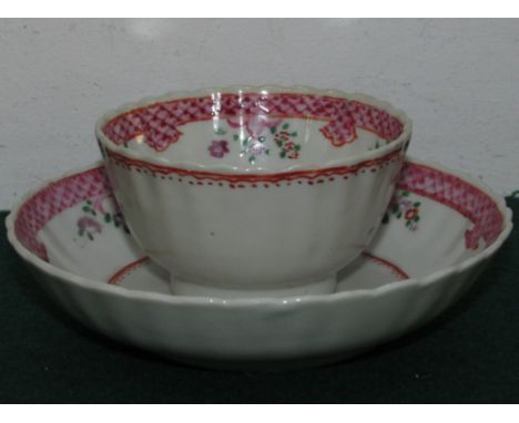 A New Hall style porcelain tea bowl and saucer, mauve and pink sprays with margins of puce scales; and a 19th century tea cup