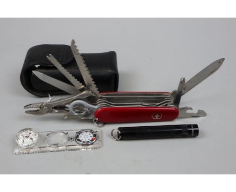 Swiss army knife in pouch with accessories to include compass magnifying glass and torch etc 