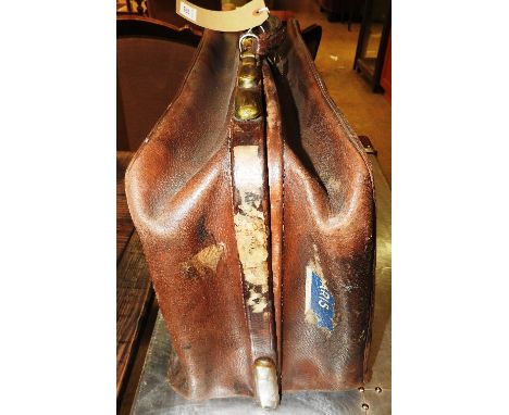 A vintage leather Gladstone type bag with brass fittings.