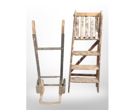 An antique sack barrow and a pine step ladder.