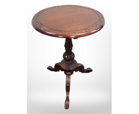 A reproduction carved mahogany tripod table in the Georgian style, height 72 cm 
