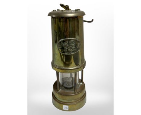 A Welsh brass miner's lamp.