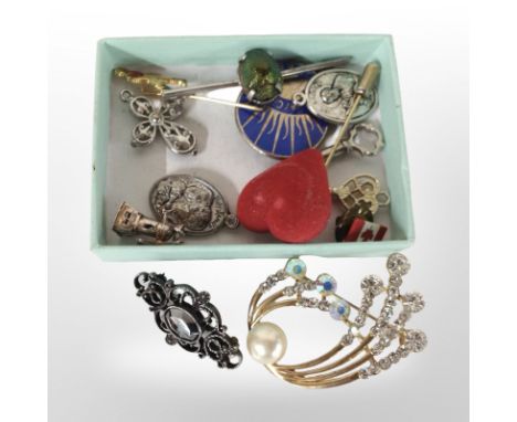 A small box containing a scarab beetle bar brooch, Johnnie Walker stick pin, other badges and brooches, etc.