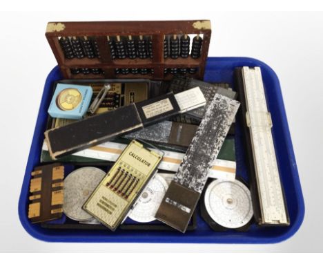An abacus, together with a group of slide rules, a bridge counter, Fowlers universal calculator in fitted case, etc.
