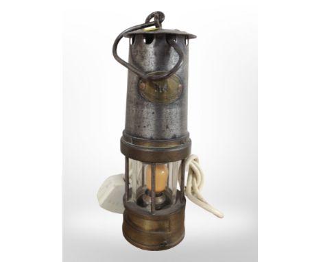 A 19th-century brass and steel miner's lamp (converted).