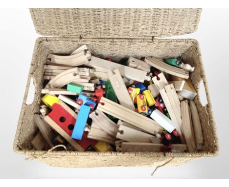 A wicker hamper containing Brio railway track and trains.
