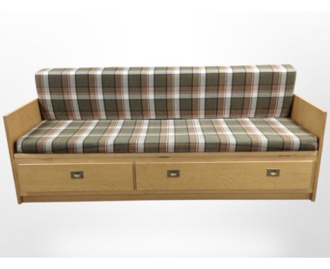 A 20th century Danish oak sofa bed with checked cushions, 195 cm x 76 cm x 80 cm 