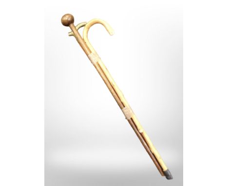 A brass-handled walking stick, a further walking stick, and an African chief's-style hardwood staff.