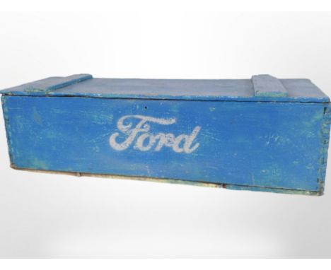 A vintage painted pine crate marked Ford containing assorted items including decorative hand axe, money box, copper mould, to