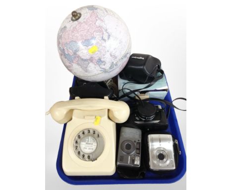 A vintage cream plastic telephone, together with several vintage and later cameras including Minolta, Canon, and a globe.