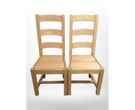 A contemporary set of six oak ladder back dining chairs 