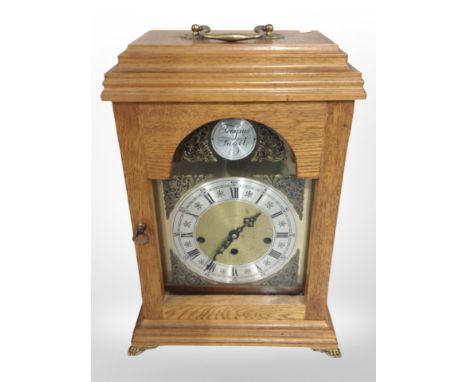A reproduction Tempus Fugit bracket clock in oak case, height 42cm.