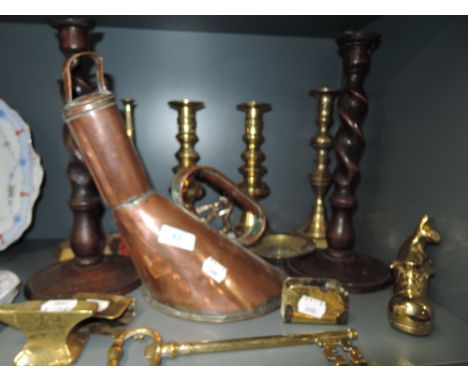 A selection of copper and brass wares including unusual form lidded vessel and candle stick pairs