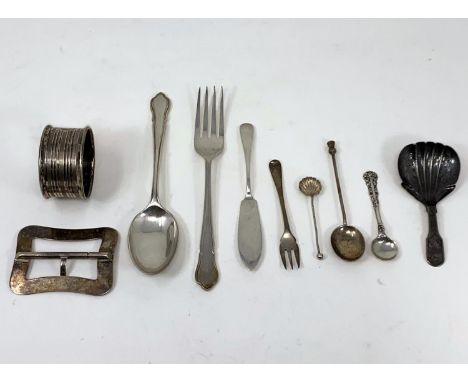 A silver christening spoon and fork; a silver buckle; a Victorian silver shell caddy spoon, salt spoons etc, various dates an