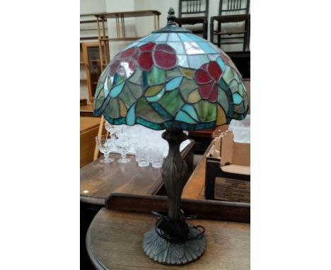 A Tiffany style bronzed table lamp with leaded coloured glass shade 