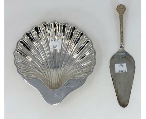 A hallmarked silver shell dish on ball feet, Birmingham 1904; a hallmarked silver pie slice with Celtic decoration, Chester 1