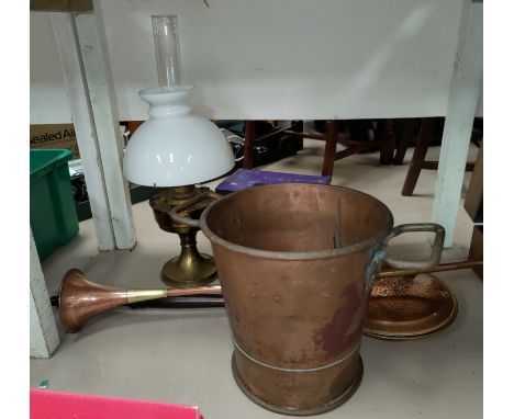 A large copper coal bucket with elongated handle. Copper horn; brass jam pans; an oil lamp etc. 