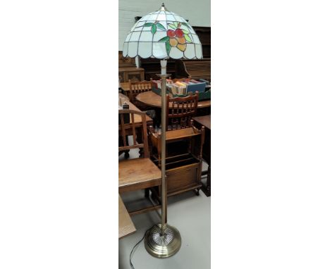 A Tiffany style brass standard lamp with leaded coloured glass shade 