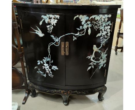 A 20th century black lacquer Chinese style floor standing corner cupboard with mother of pearl decoration 
