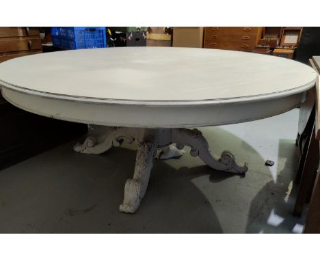 A Victorian style very large dining table in light grey 'shabby chic' finish, circular top with carved central pillar and 4 s