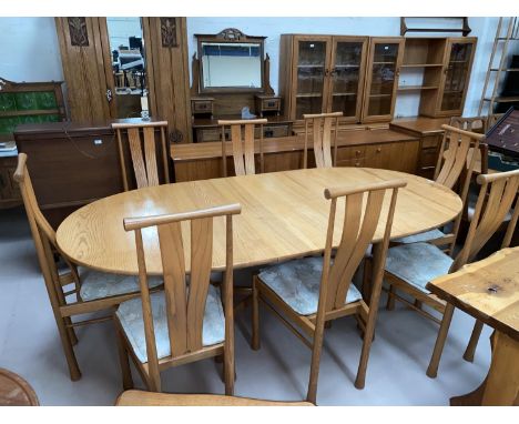 An Ercol light elm dining suite comprising extending 'D' end table on trestle base, extended length 210 cm, and 8 high back c