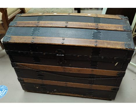 A late Victorian wood and metal bound domed top trunk with interior fitting 76cm 