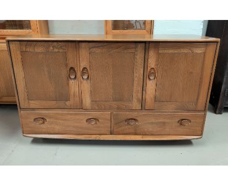 An Ercol light oak sideboard of 3 cupboards and 2 drawersLength 130cm, Height 76cm, width 49.5 narrows to 43cm 