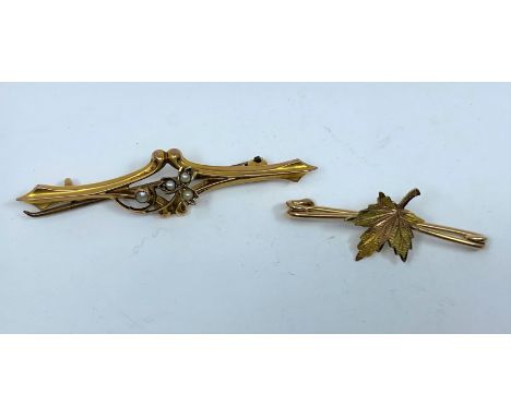 An Edwardian seed pearl set bar brooch, stamped '9ct'; a maple leaf bar brooch, stamped '10K, 3.4 gm 