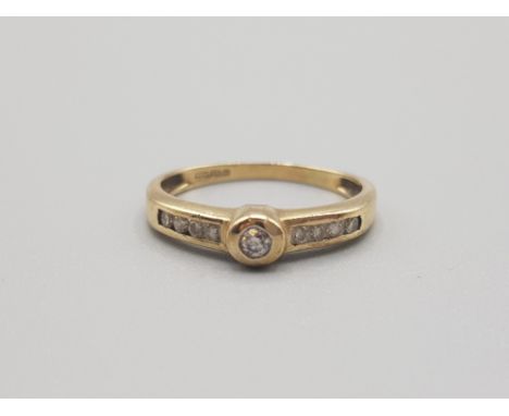 Ladies 9ct yellow gold diamond ring comprising of a brillaint round cut diamond set in the centre with 4 diamonds set on each
