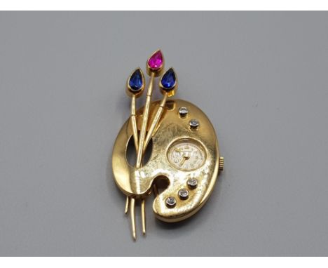 Ladies 18ct yellow gold diamond brooch with clock featuring 2 blue sapphires and 1 ruby set in the flowers with 4 brilliant r