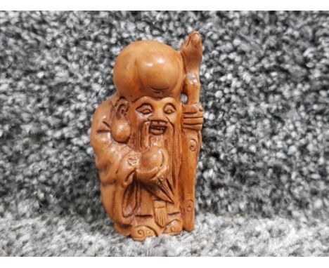 Hand carved hardwood netsuke depicting elder with staff