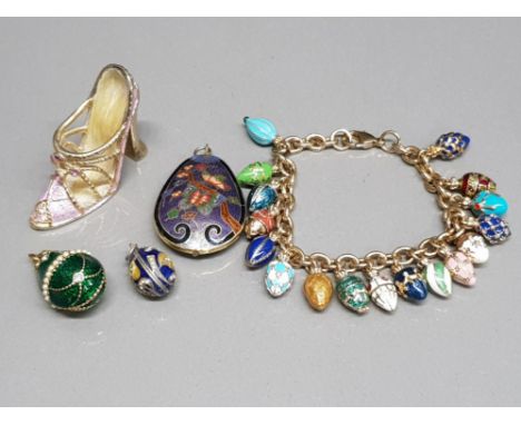 A faberge egg style charm bracelet, two similar pendants an enamel pendant and shoe