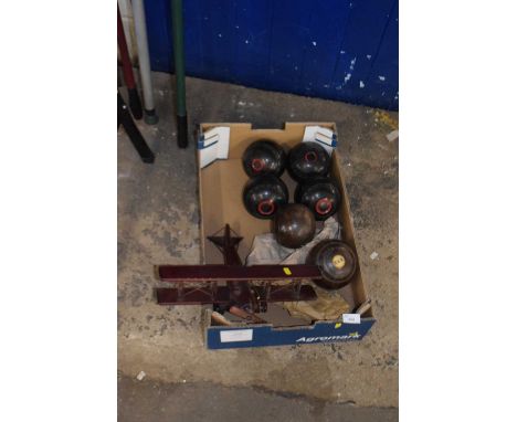 Box containing wooden model aeroplane together with a set of lawn bowls