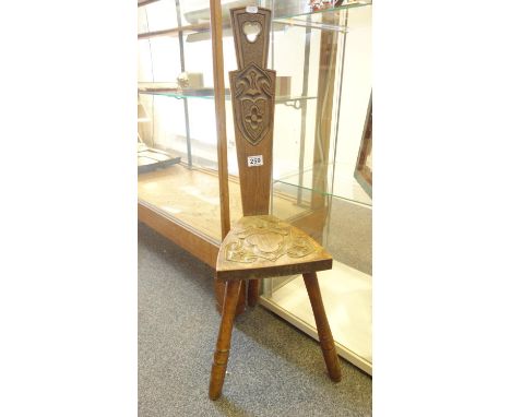 Arts & Crafts oak milking chair on tripod supports with carved seat and back