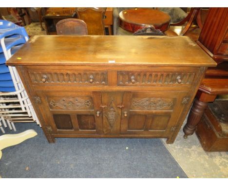 A VINTAGE CARVED OAK SIDEBOARD 