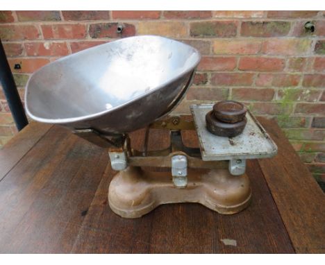 A SET OF GREEN GROCERS SCALES WITH TWO WEIGHTS