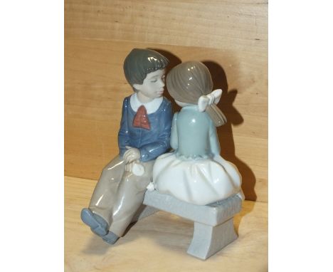 A&nbsp;NAO&nbsp; FIGURE OF A BOY AND GIRL ON A BENCH, MODEL NUMBER 1136