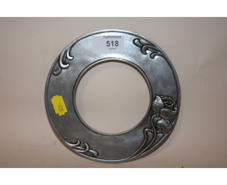 AN ART NOUVEAU PEWTER CIRCULAR PICTURE FRAME