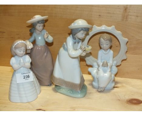 FOUR SMALL NAO&nbsp;FIGURES, TO INCLUDE A SEATED BOY MODEL NUMBER 1445, THE OTHERS WITHOUT MODEL NUMBER
