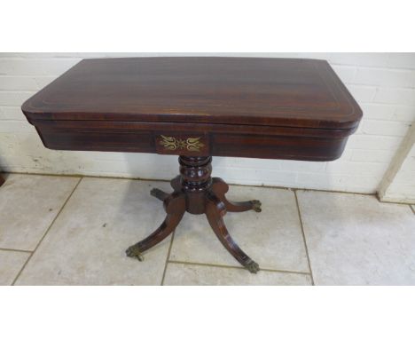 A well restored early 19th Century fold-over rosewood card table with brass inlay - 74cm tall x 92cm 