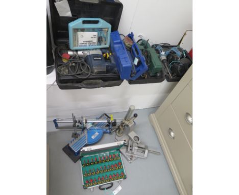 A selection of 4 power tools and attachments and a boxed set of Routers, 1 drill and 3 sanders, a Titan 6kg SDS Plus Rotary H