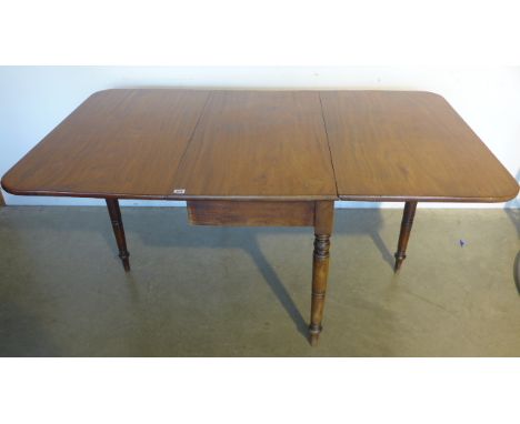 A mahogany drop leaf dining table raised on turned supports with gate leg action - 94cm x 157cm x 73cm high 