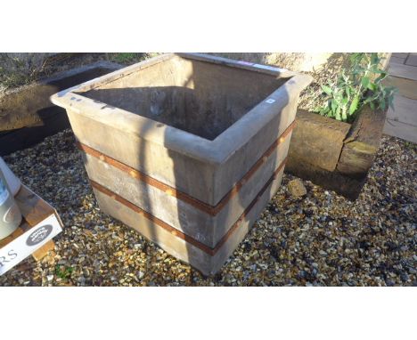 A Bramblecrest Venetian square planter with a metal band 