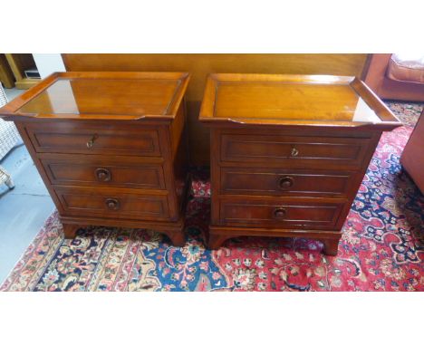 A pair of modern bedside chests, glass topped each with three drawers and raised on bracket supports - 41cm x 62cm x 69cm hig