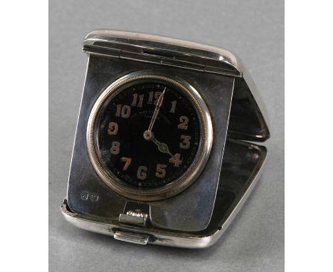 A silver travel clock by John Bennett, London, the black enamel dial with Arabic numerals, the case initialled 'P.A.C.'.