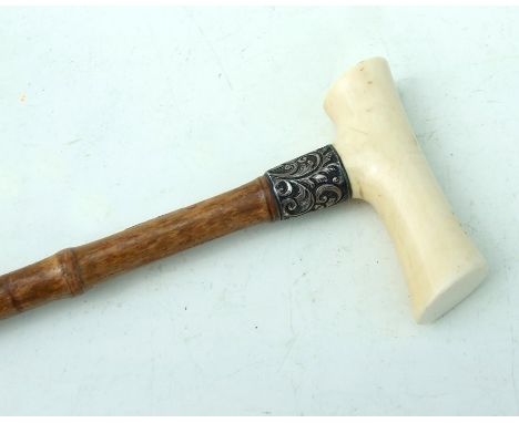 An ivory handled bamboo walking stick with silver collar, 90cms (35.5ins) long.