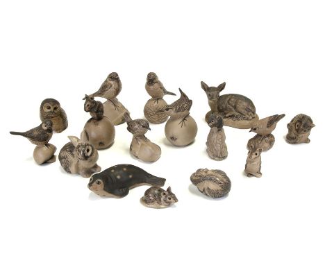 A quantity of Poole Pottery stoneware animals to include a seal, a mouse on an apple, a fawn and an owl. 