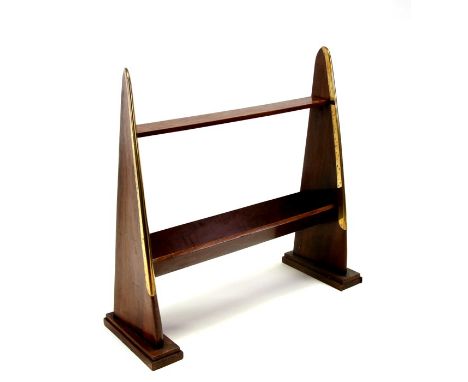 A mahogany propeller bookcase, having a top flat shelf above a V shaped trough, the supports made from propellers with brass 