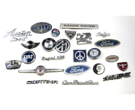 A large quantity of bonnet badges for various marques including Ford, BMW, Volkswagen, Range Rover, Austin, Reliant, Morris a