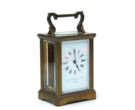 A four-pillar gilt brass carriage clock, the rectangular enamel with Roman numerals and signed 'H J Cooper &amp; Co London', 